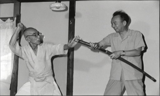 Takamatsu sensei demonstating muto-dori ("no sword") technique with director Yamamoto Satsuo